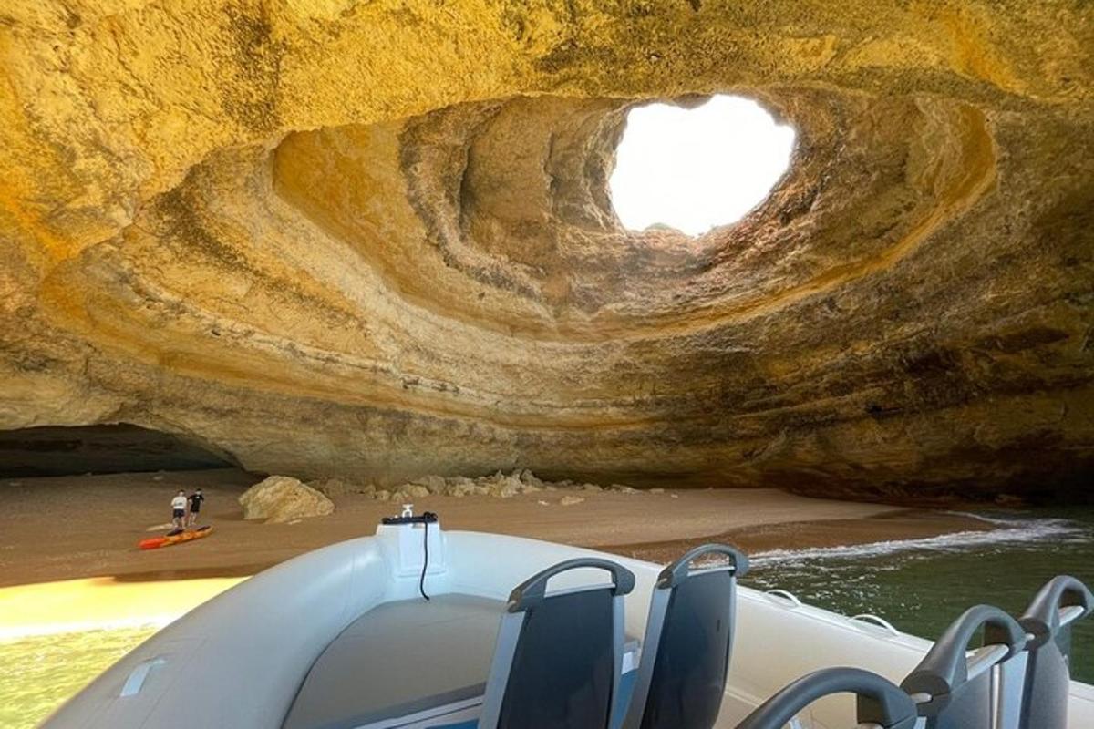 a boat in front of a large rock formation