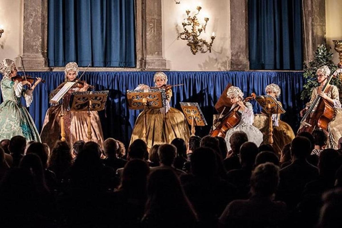 a group of women on a stage in front of a crowd