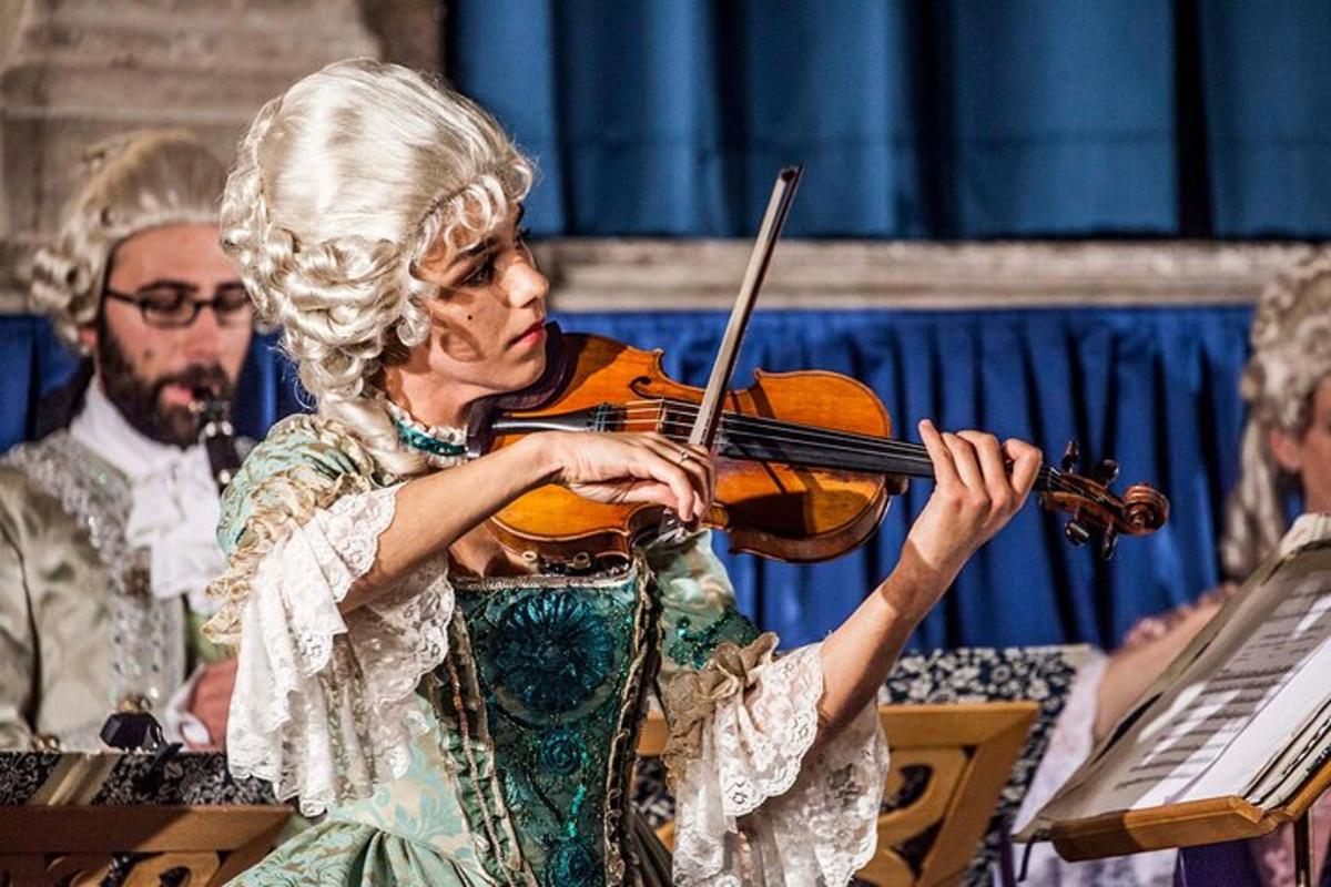 a woman playing a violin in a performance