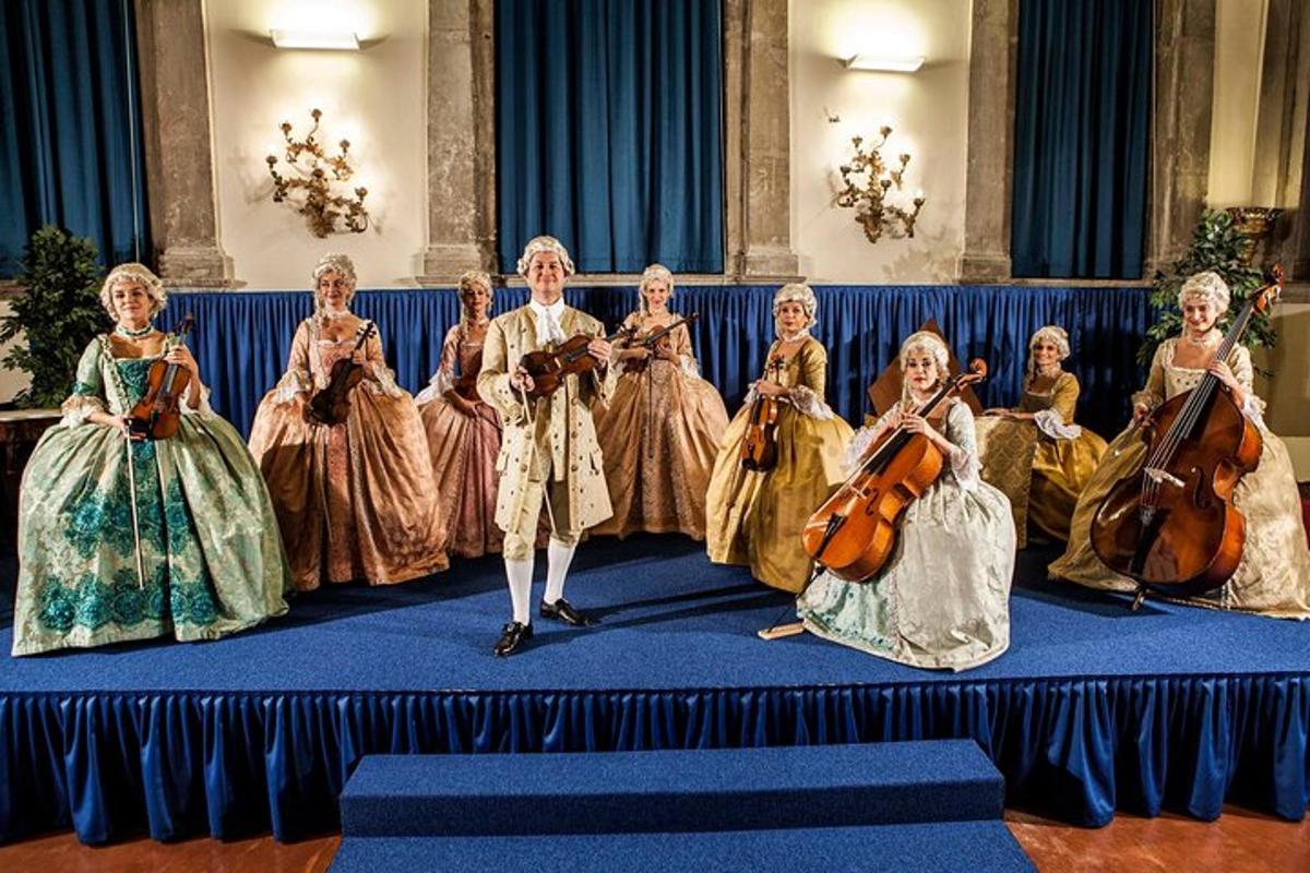 a group of women in dresses sitting on a stage