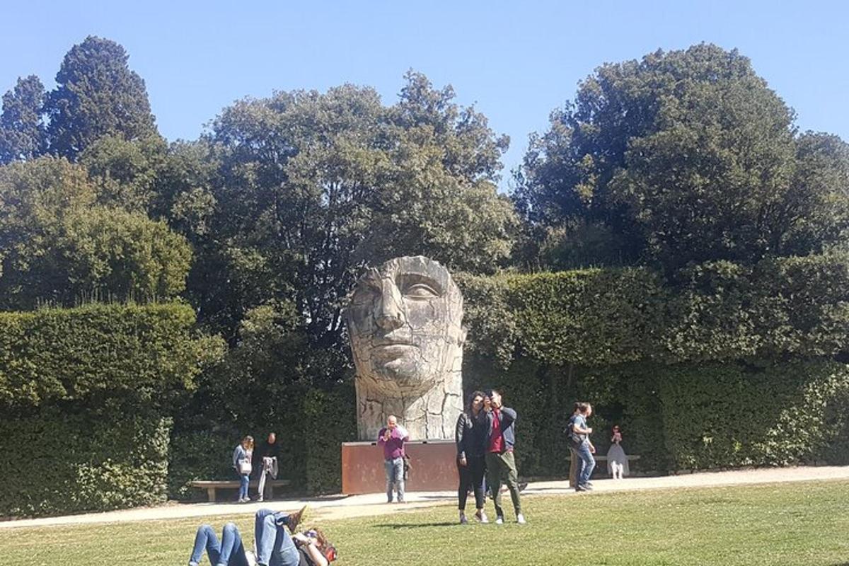 Un grupo de personas de pie frente a una estatua