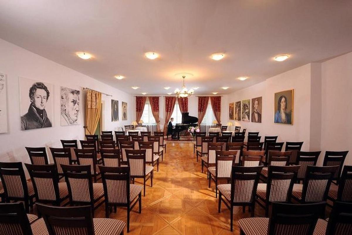 a large room with rows of chairs and a piano