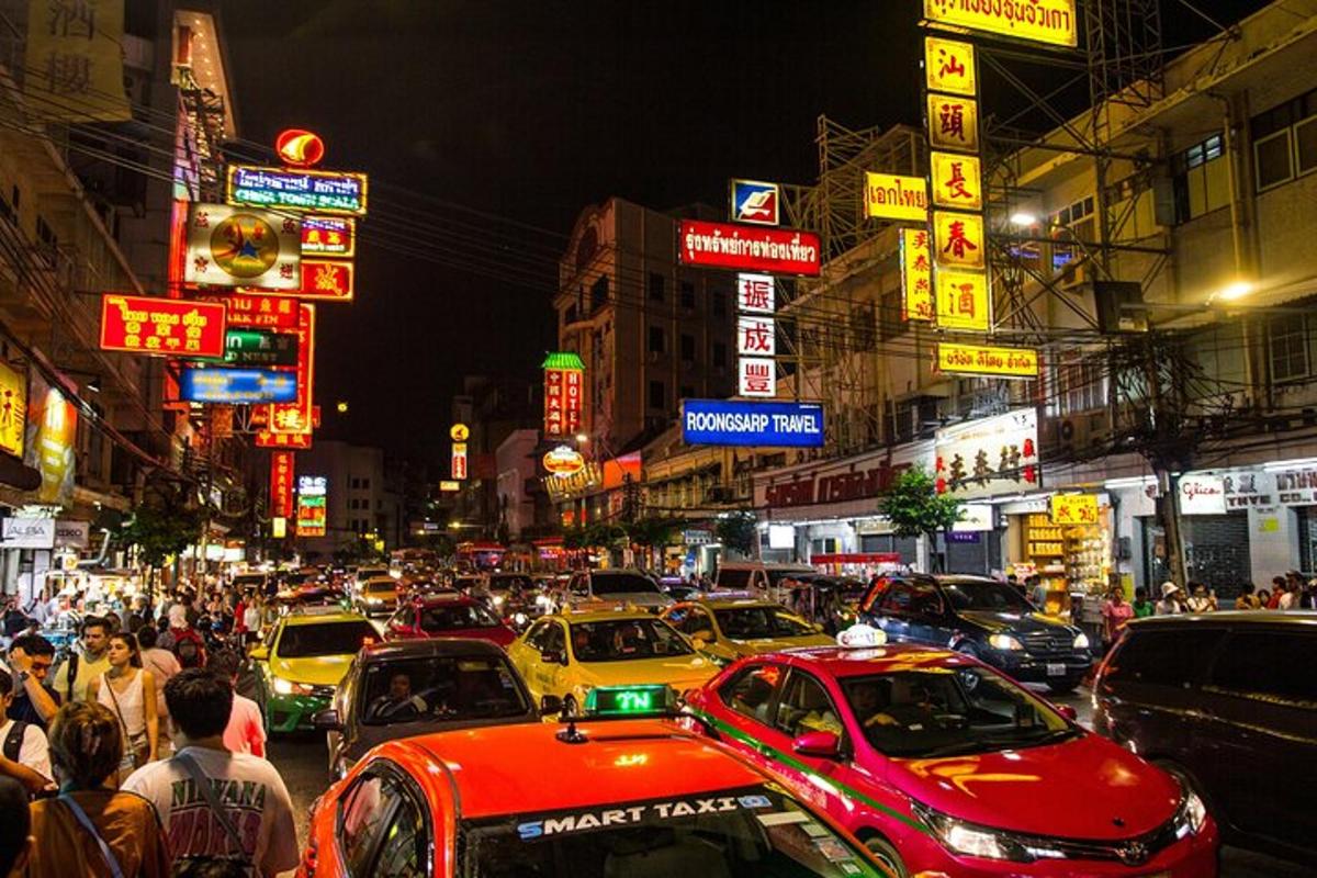 a busy city street filled with lots of cars and signs