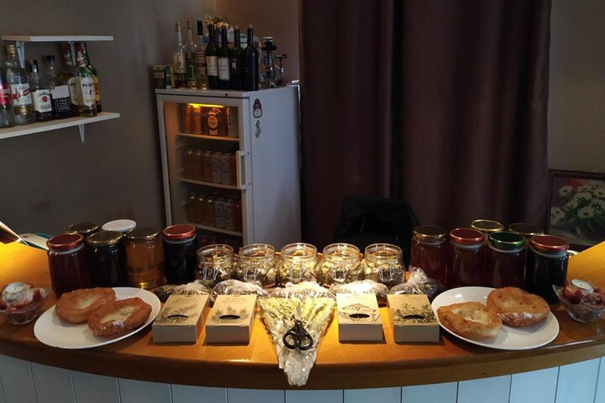 a table topped with plates of pastries and jars of food