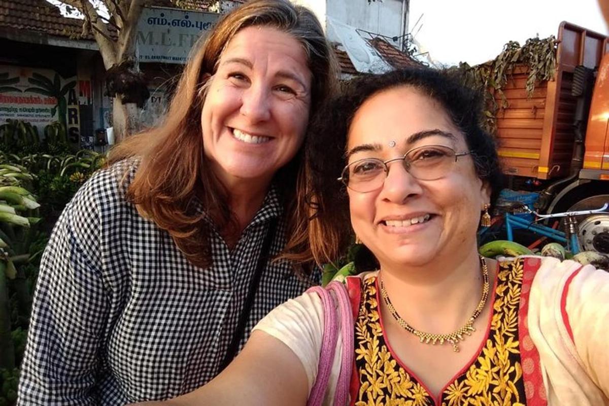 two women sitting next to each other in a market