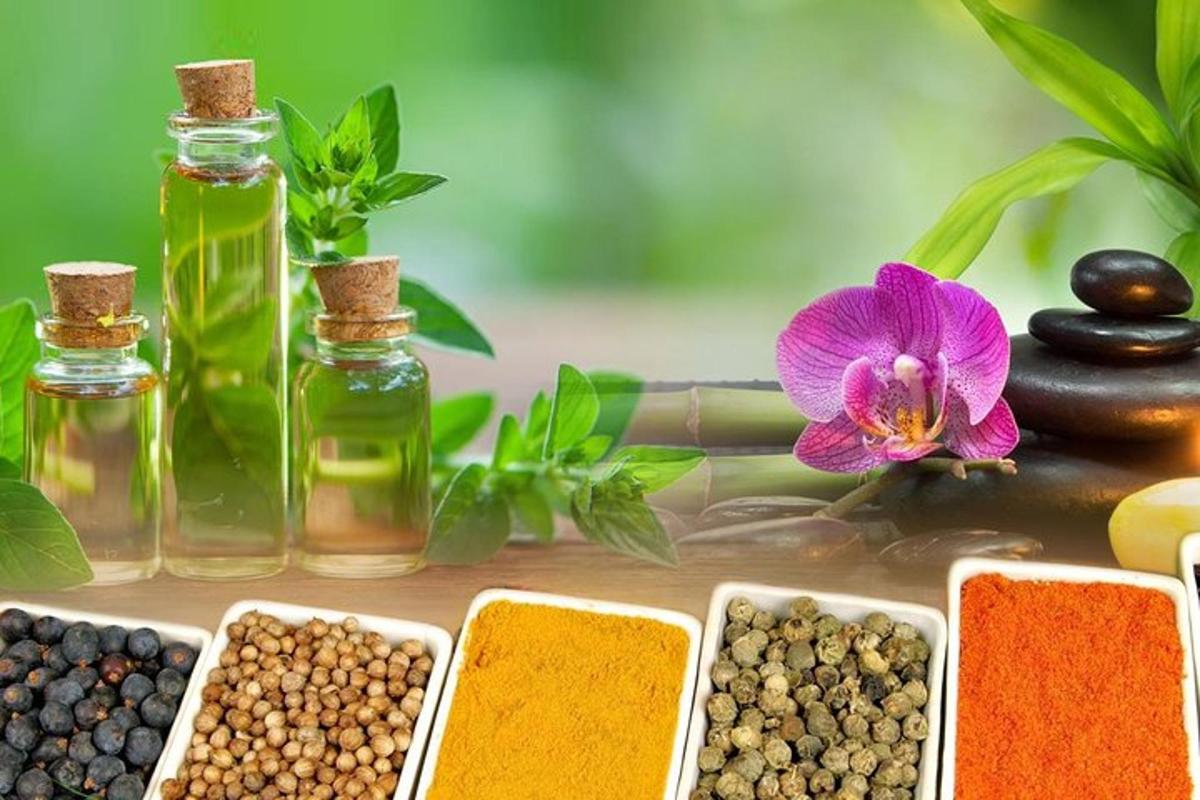 una selezione di oli essenziali e semi e un fiore