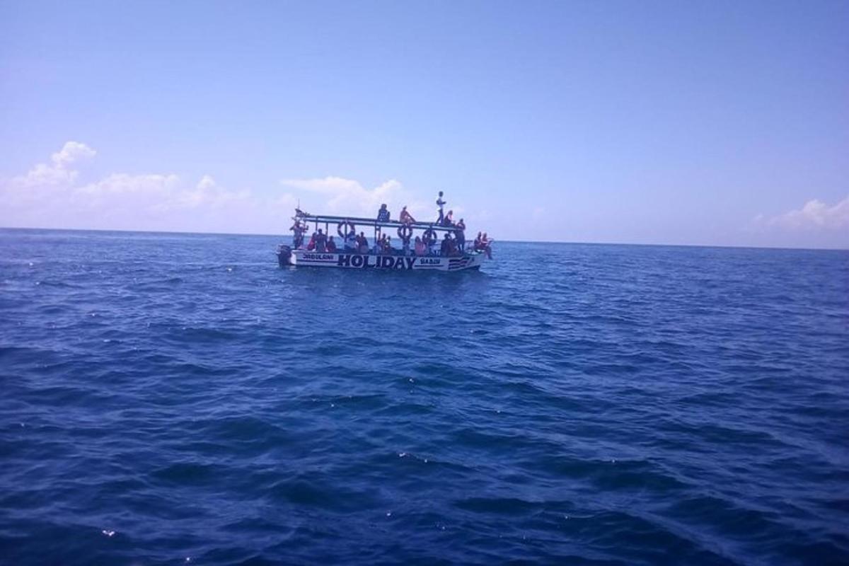a group of people on a boat in the ocean