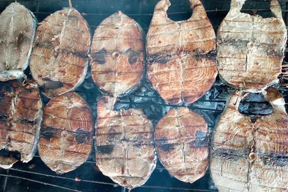 a bunch of food cooking on a grill