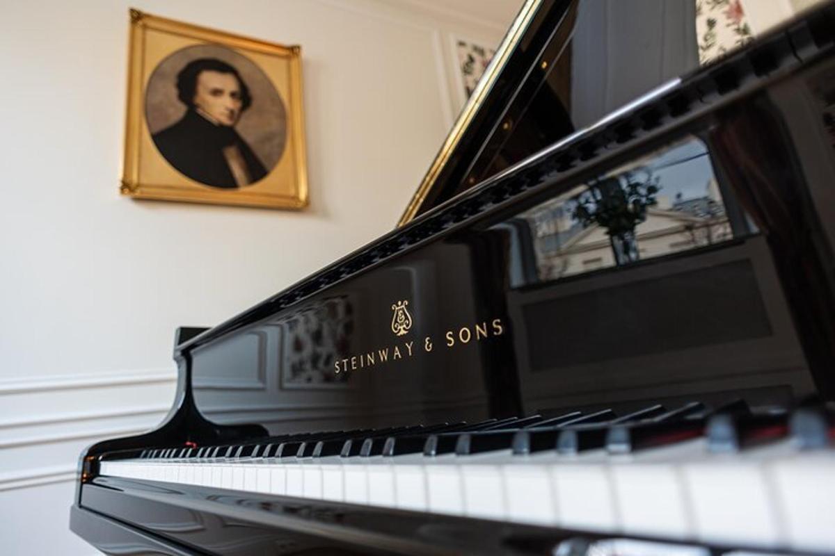 a piano with a picture of a man on the wall
