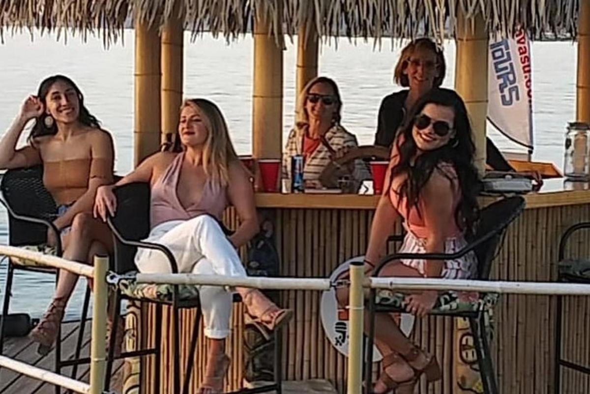 a group of women sitting at a bar on a boat
