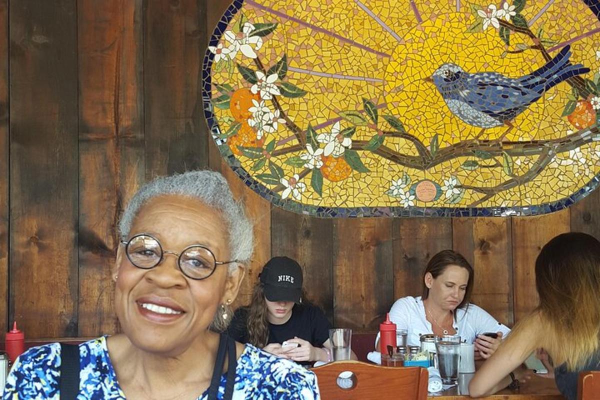 an older woman sitting at a table in a restaurant