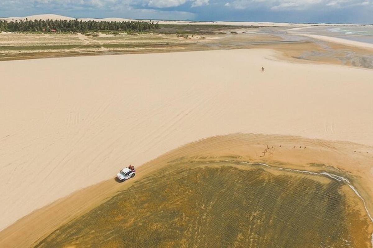 an aerial view of a car on the beach