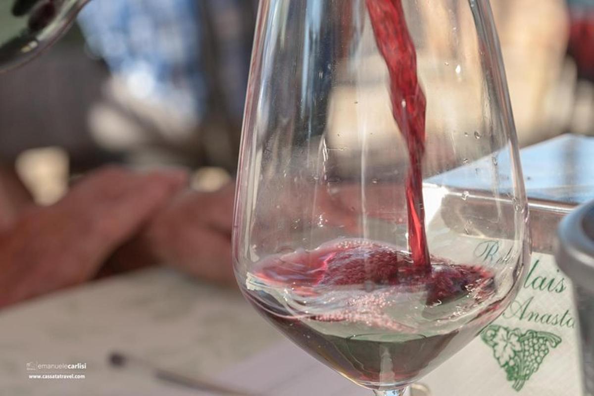 a red wine being poured into a wine glass