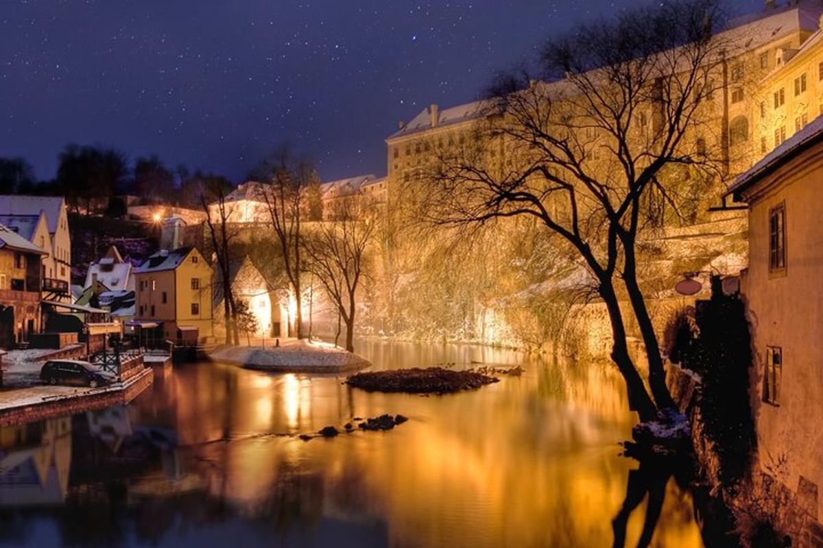 a view of a river at night with buildings