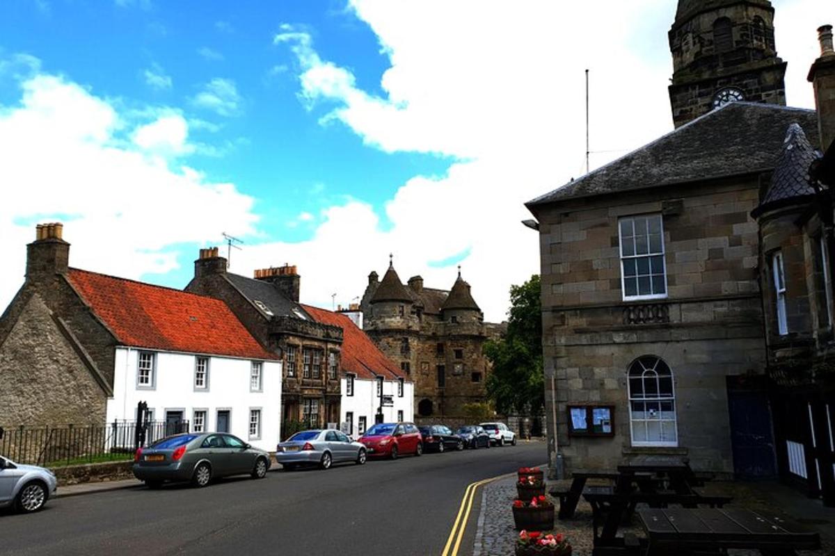 a town with cars parked on a street with buildings