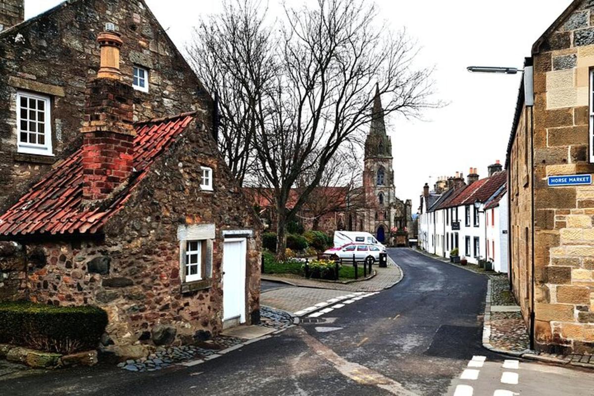 an old stone building on the side of a street