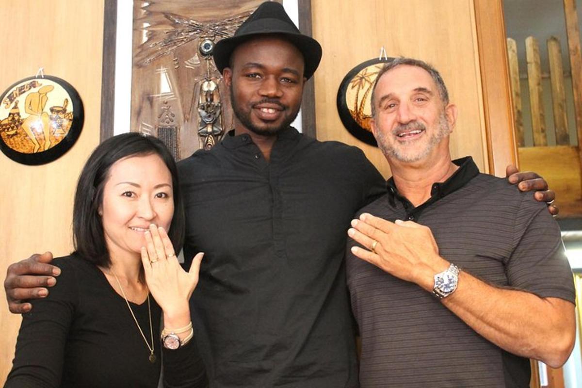 two men and a woman posing for a picture