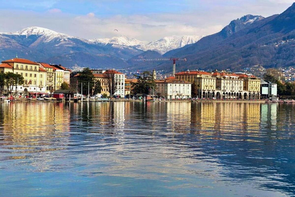a large body of water with buildings and mountains
