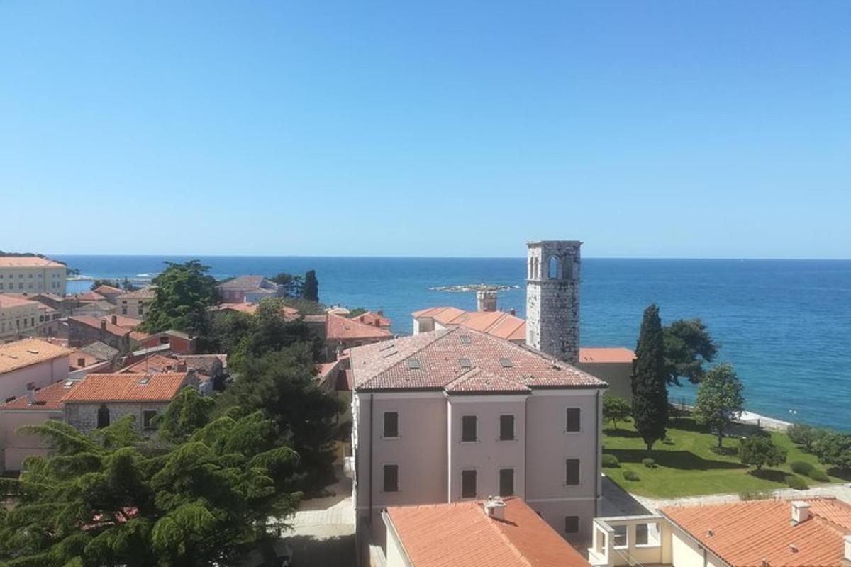 a view of a town with the ocean in the background