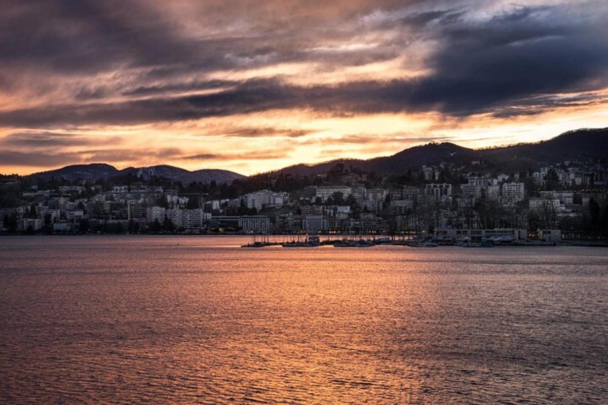 a view of a city from the water at sunset