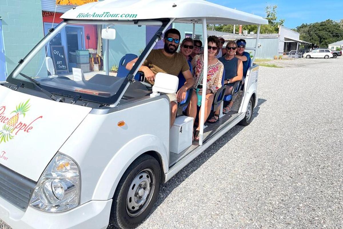 a group of people riding in a golf cart