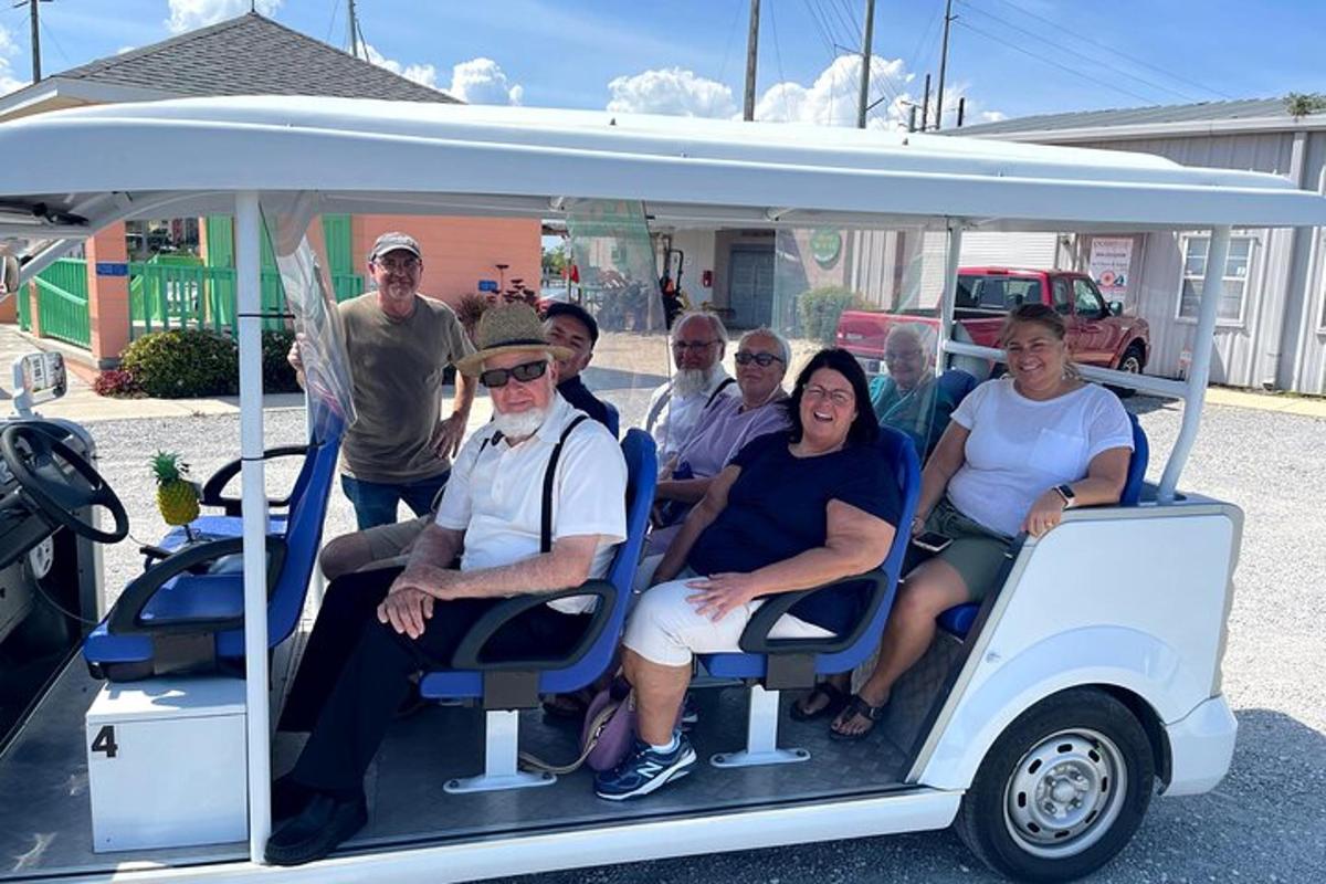 a group of people sitting in a golf cart