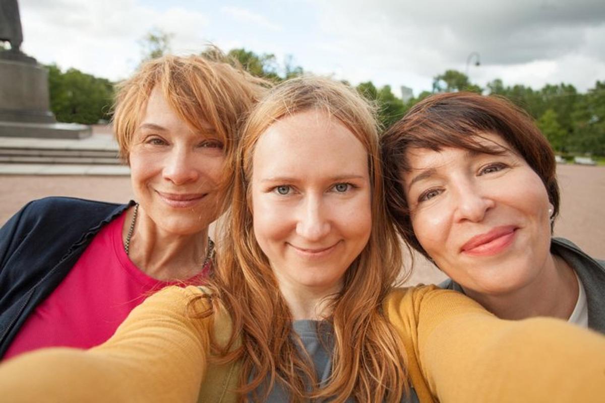 a group of three women posing for a picture