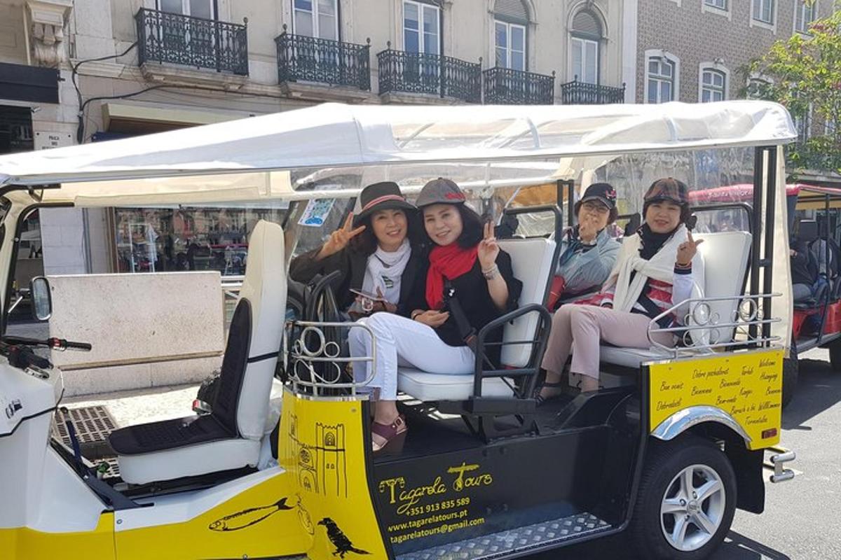 a group of women riding in a golf cart