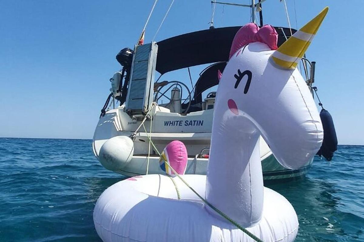 a boat with a unicorn float in the water
