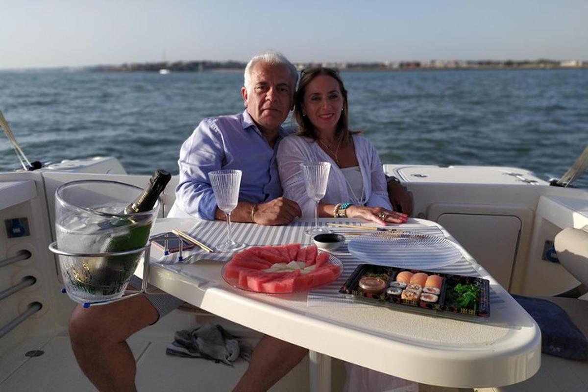 a man and woman sitting at a table on a boat