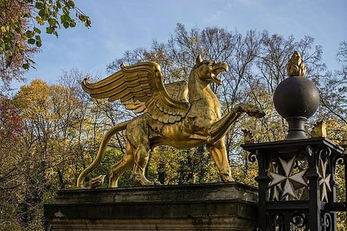 en gullstatue av en løve på toppen av en bygning