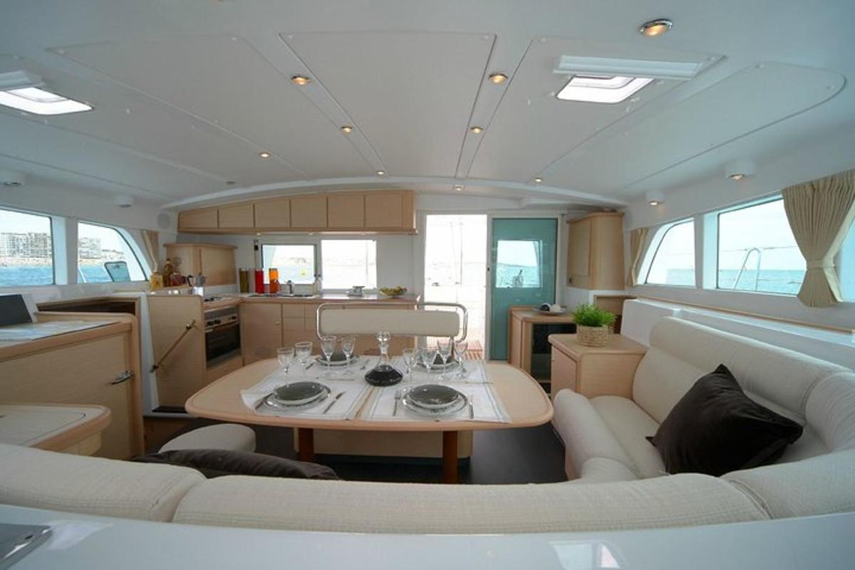 a dining room and kitchen of a boat with a table