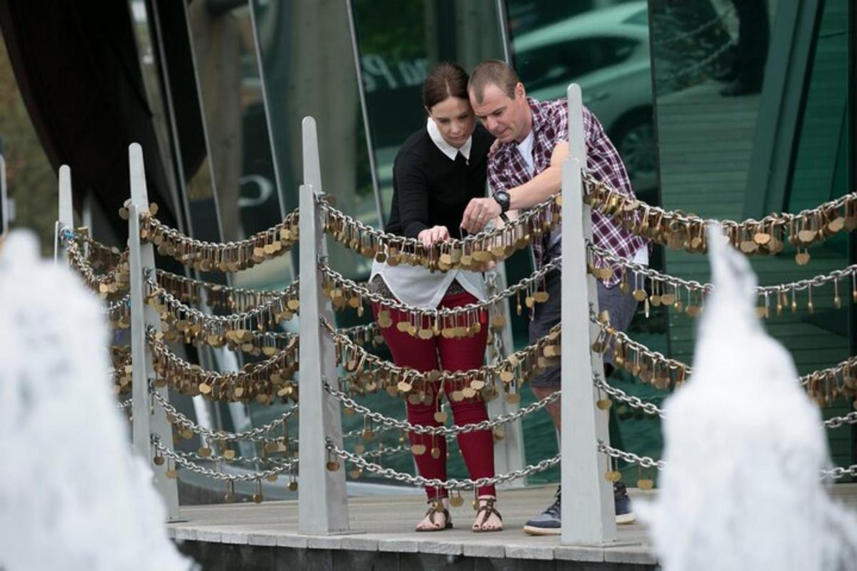 a man and a woman standing next to a garland