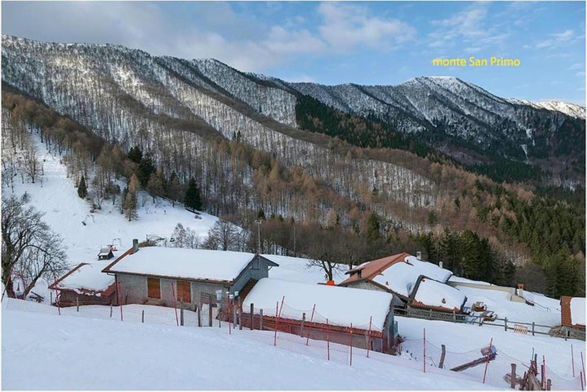 a house in the snow with mountains in the background