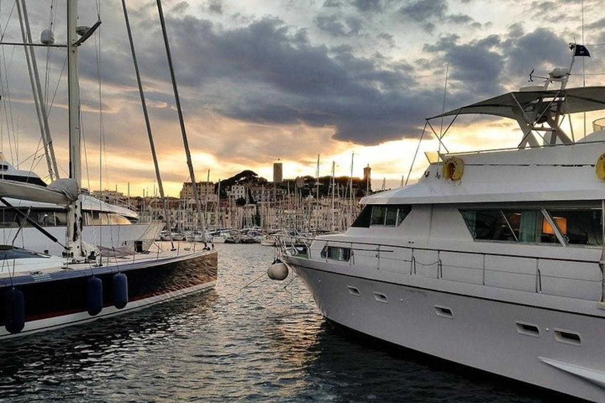 two boats docked in a harbor with a cloudy sky