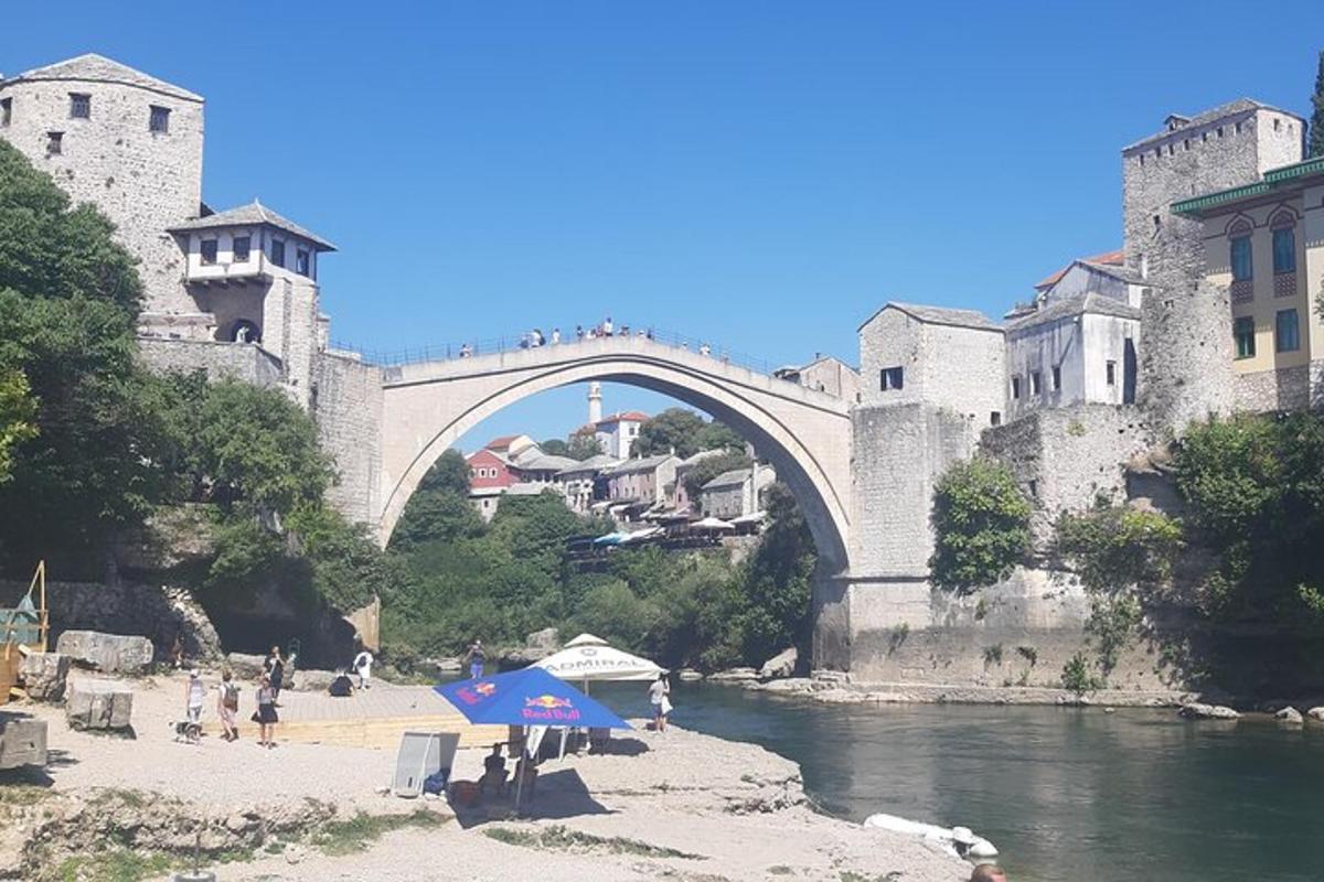 most čez reko z ljudmi, ki sedijo pod dežnikom