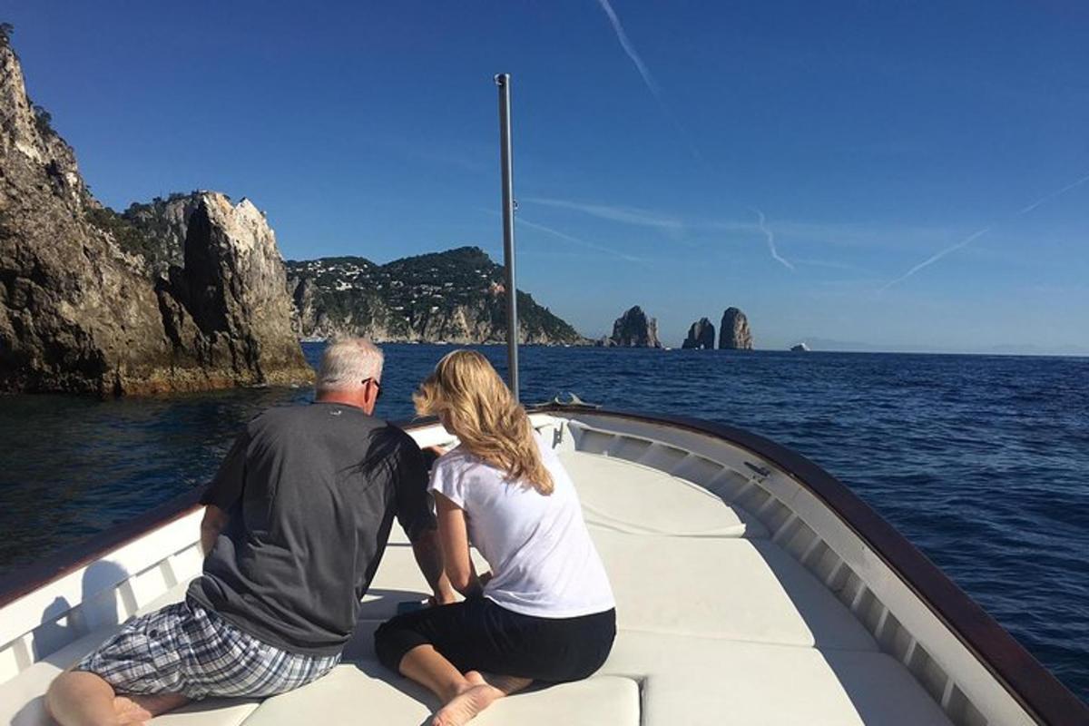 a man and woman sitting on a boat in the water