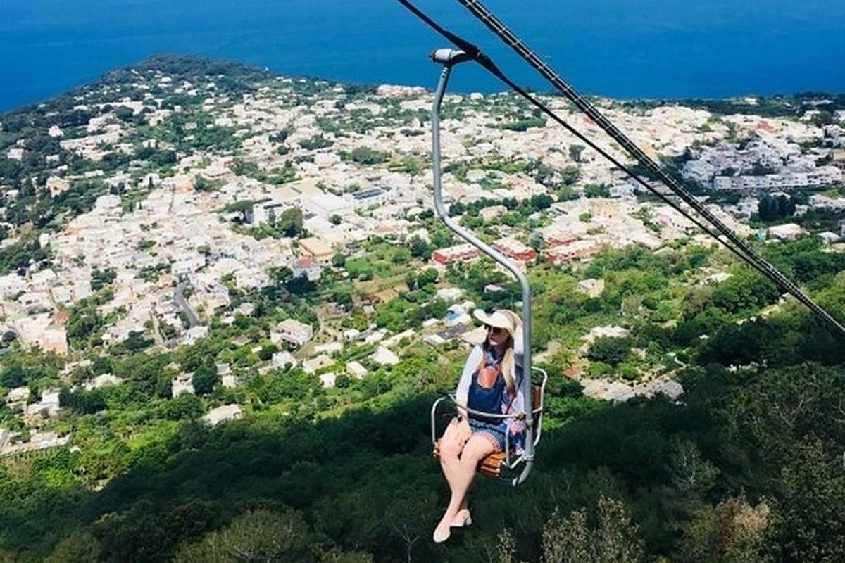 a woman sitting on a gondola in the sky