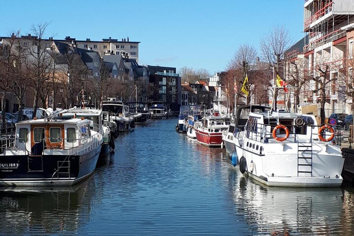 a group of boats are docked in a canal