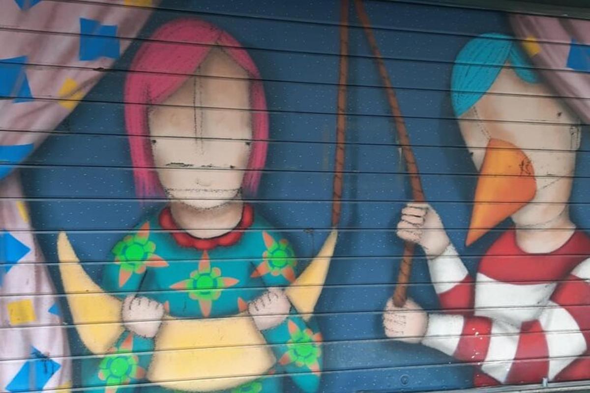 a painting of two girls on a wall