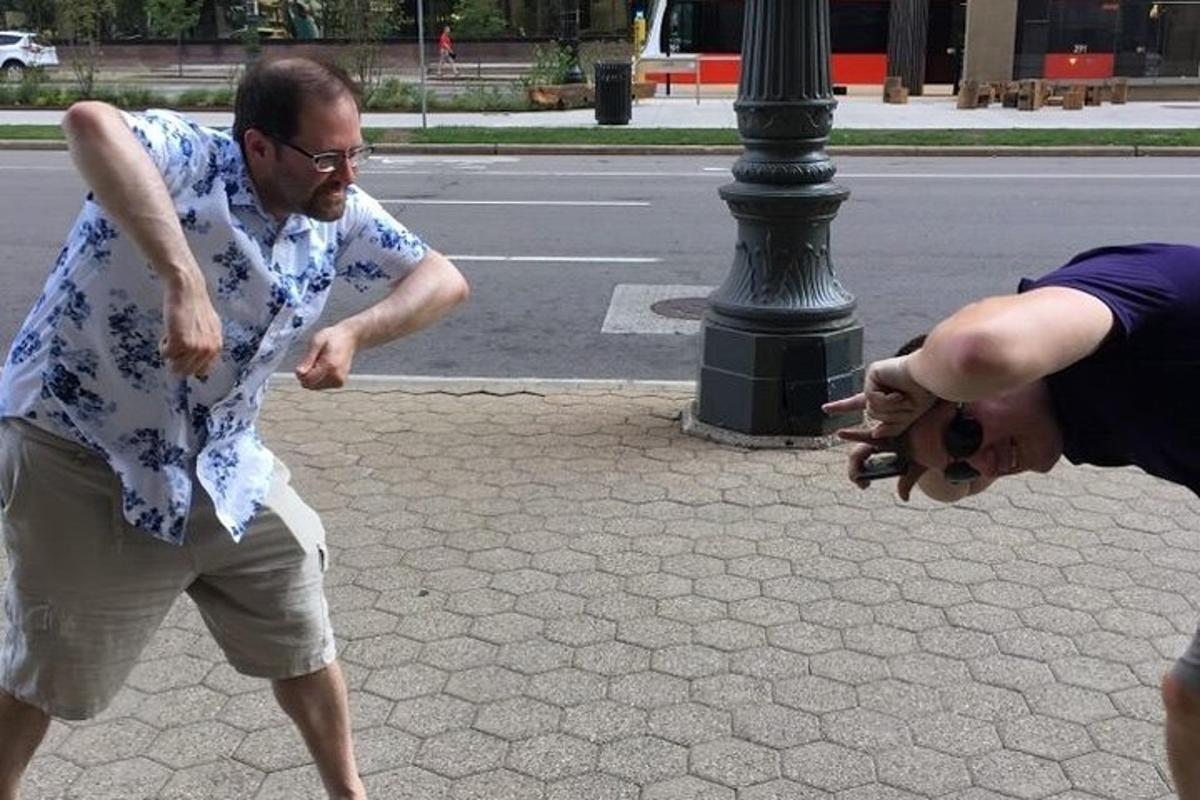 a man taking a picture of a woman on the street