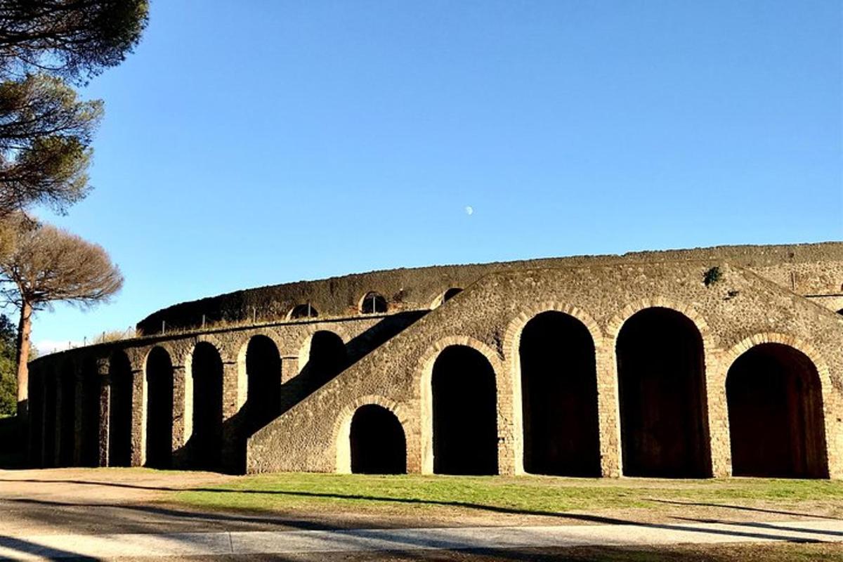 a stone bridge with arches on the side of a road