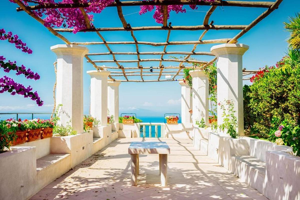 a bench on a patio with a view of the ocean