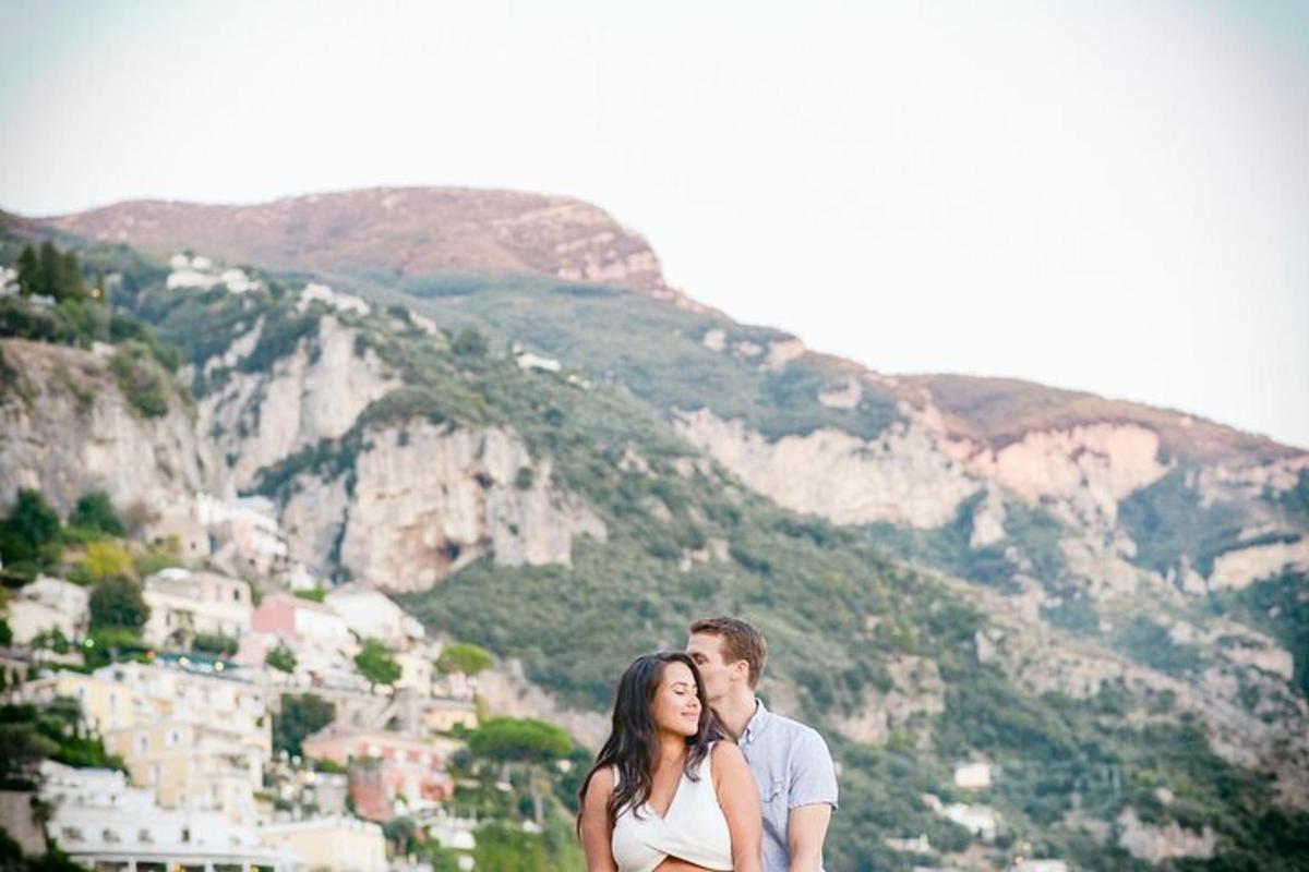 a man and a woman standing in front of a mountain