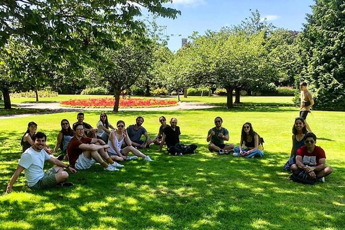 a group of people sitting on the grass in a park