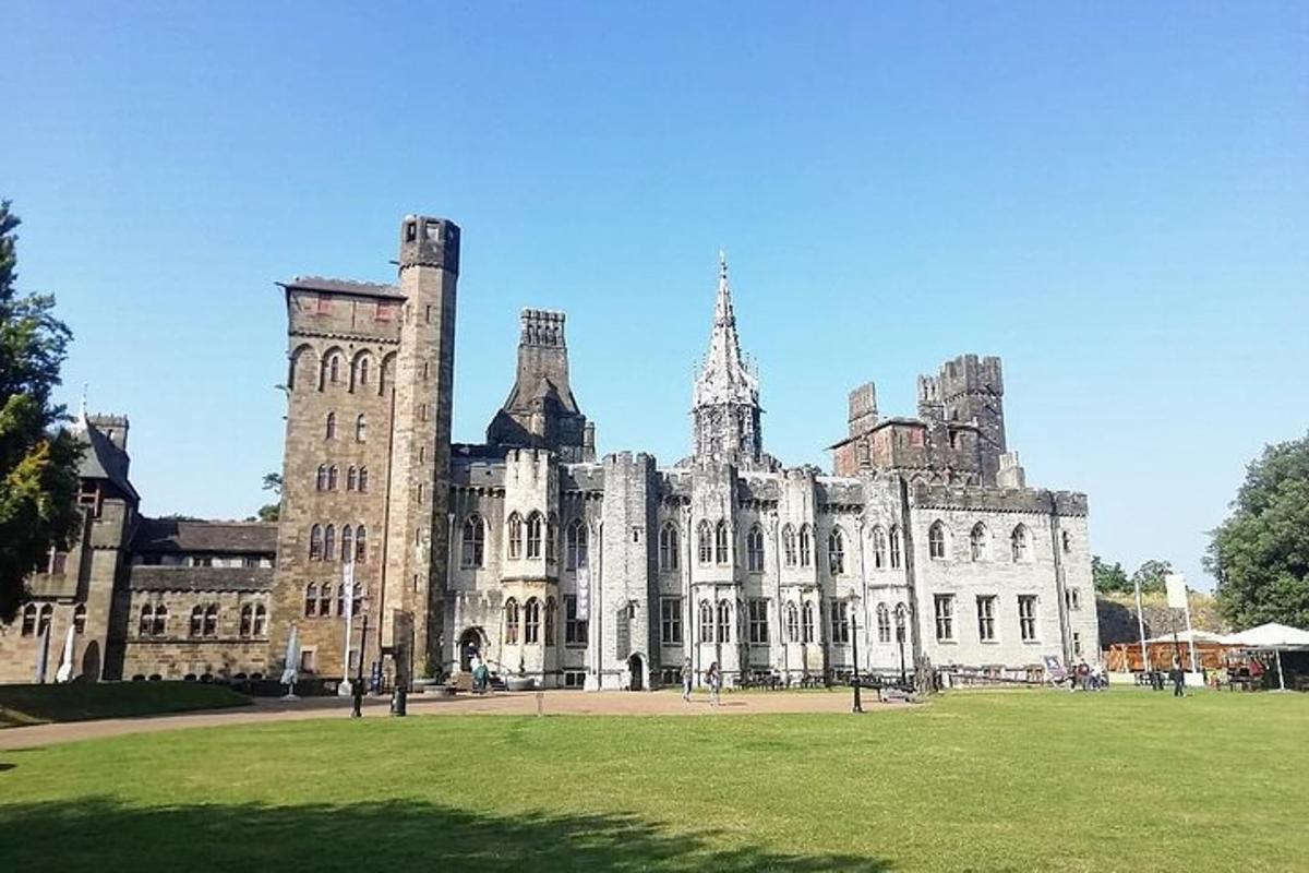a large building with a grass field in front of it