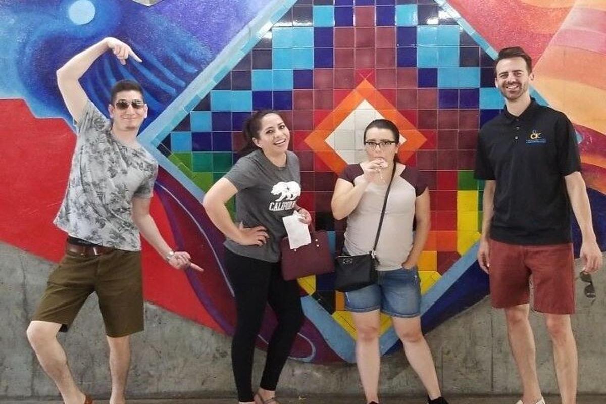 a group of people standing in front of a wall