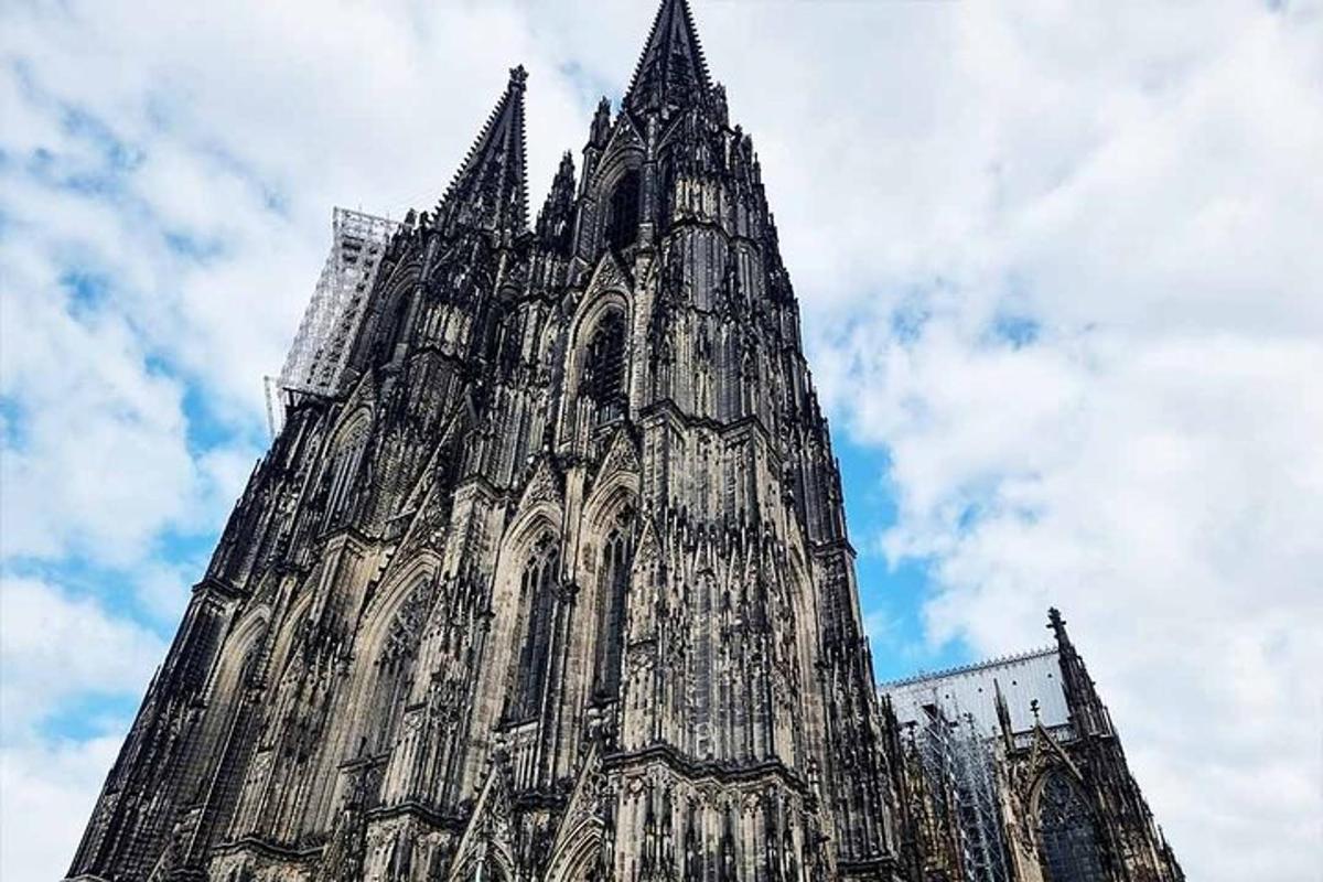 a large tower of a cathedral with a cloudy sky