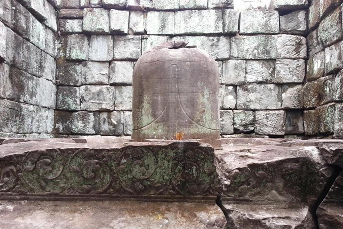 a stone bench in front of a stone wall