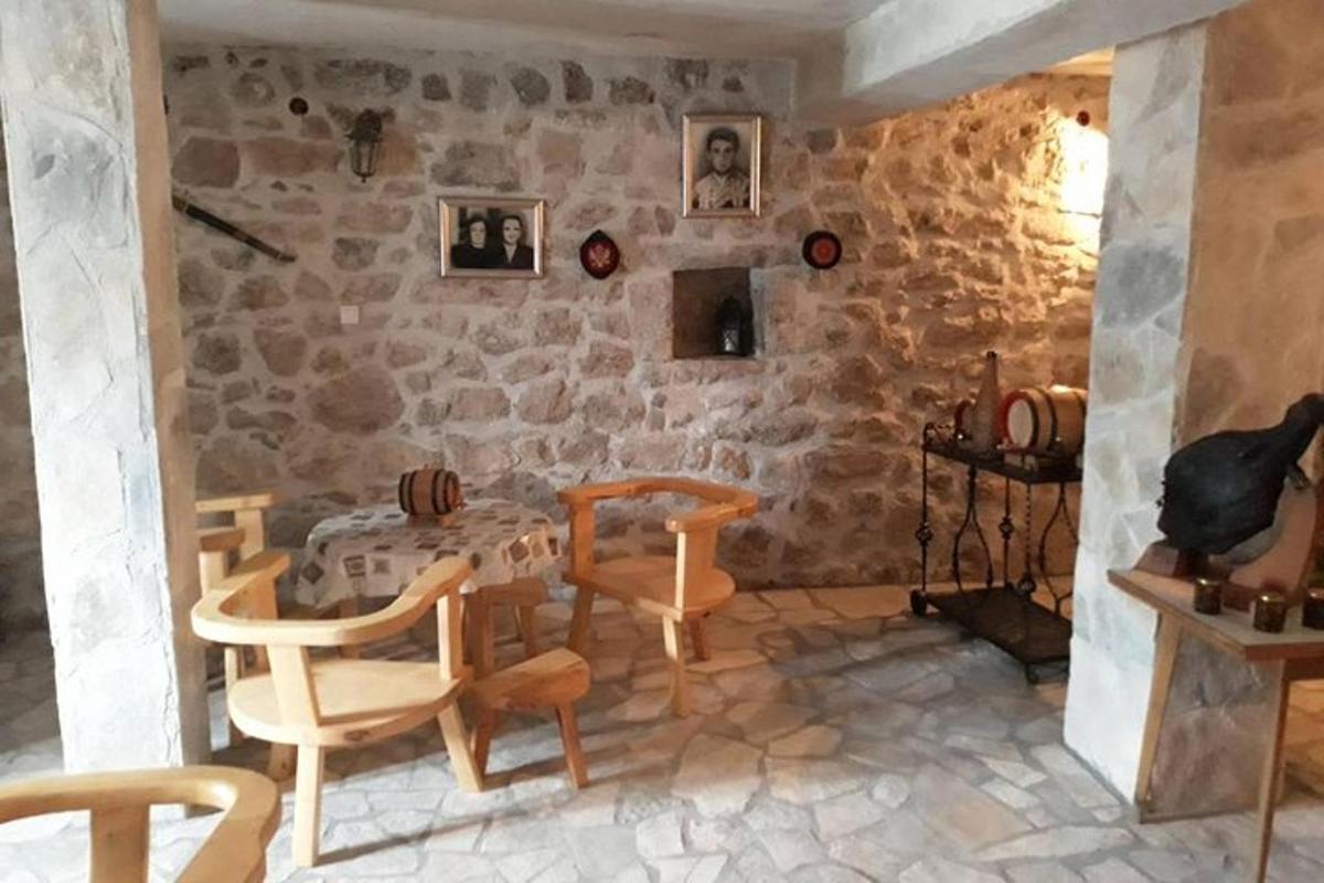 o cameră cu o masă și scaune și un zid de piatră
